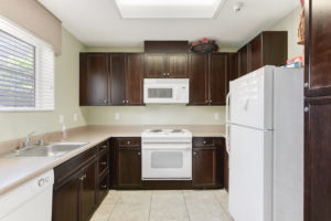 kitchen with brown cabinets and white appliances