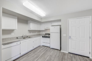 large kitchen with white cabinets and white appliances